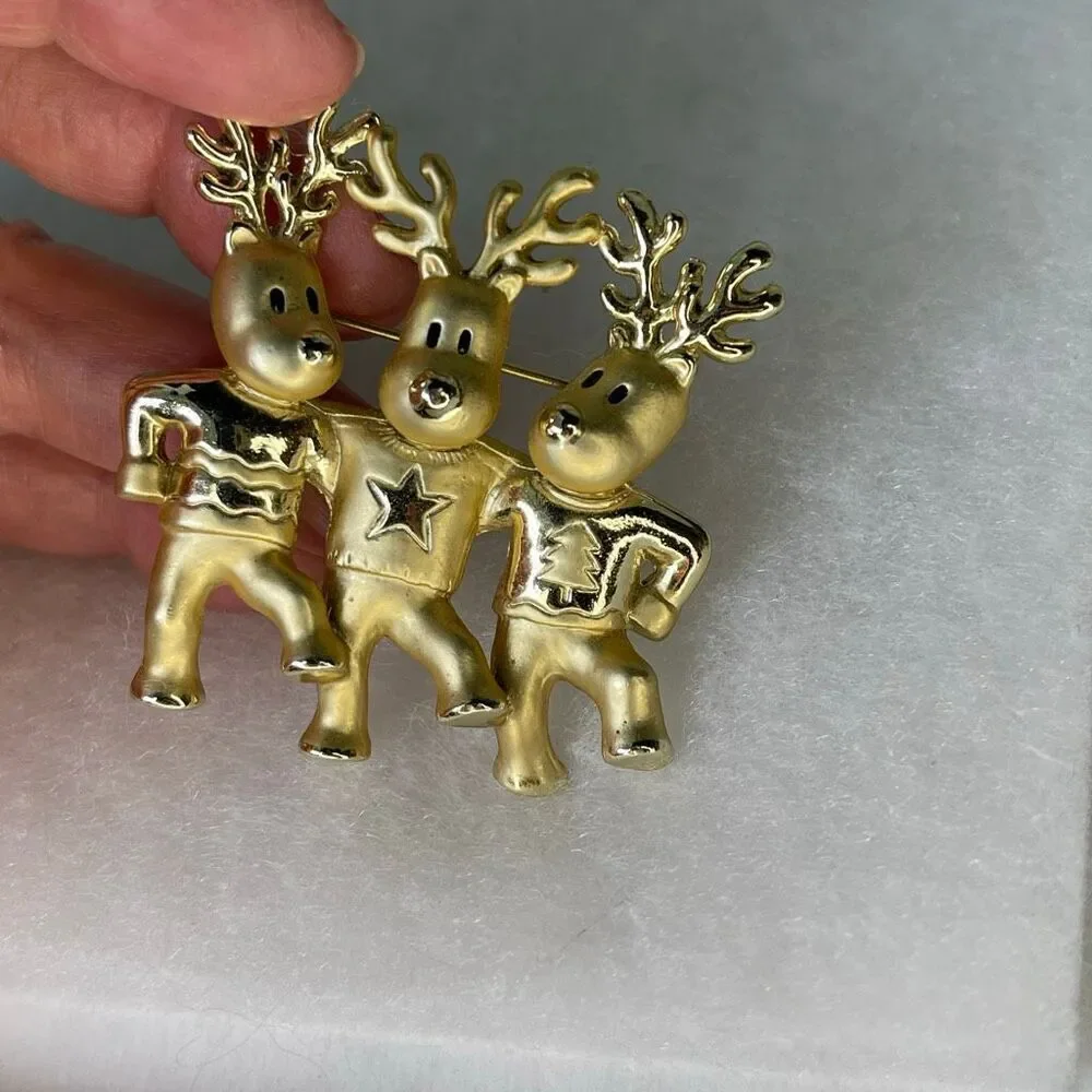 Vintage AJC three dancing deer gold tone brooch.